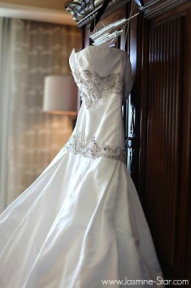 Wedding dress hanging from wardrobe
